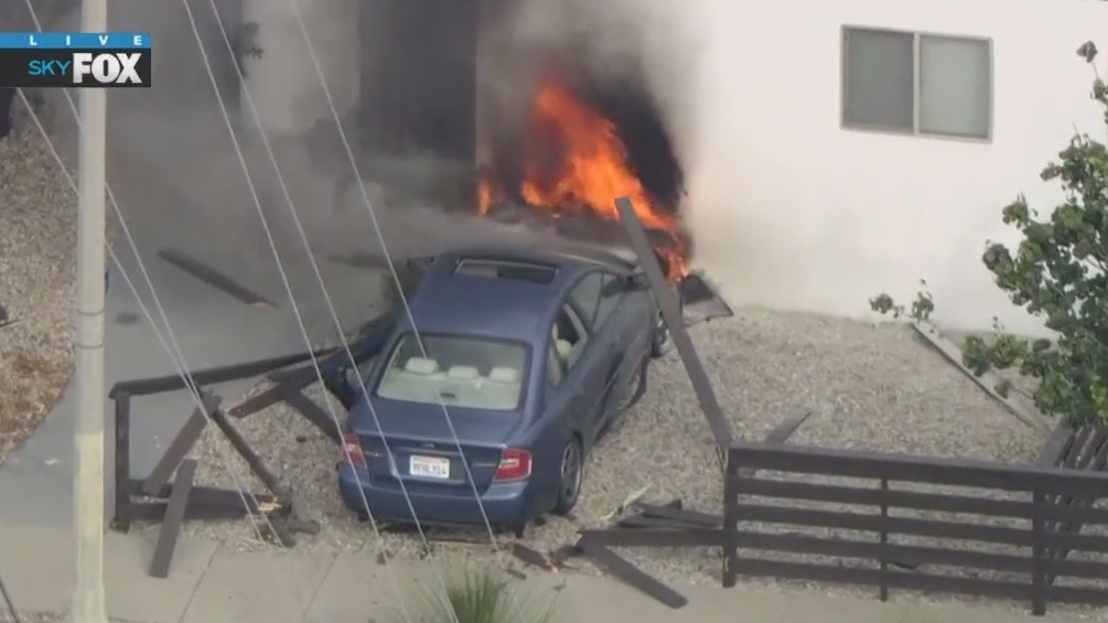 Pursuit driver crashes into home