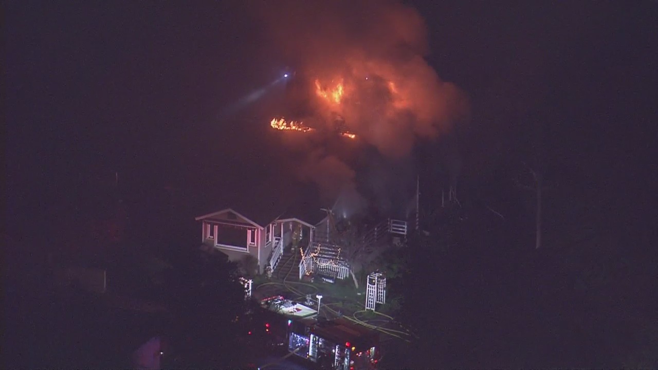 Firefighters battling a house fire in Sun Valley