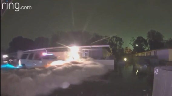 Floodwater halfway up a police cruiser