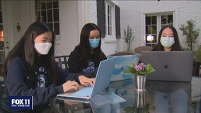 Group of high schoolers heling seniors book vaccine appointments