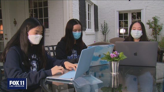 Group of high schoolers heling seniors book vaccine appointments