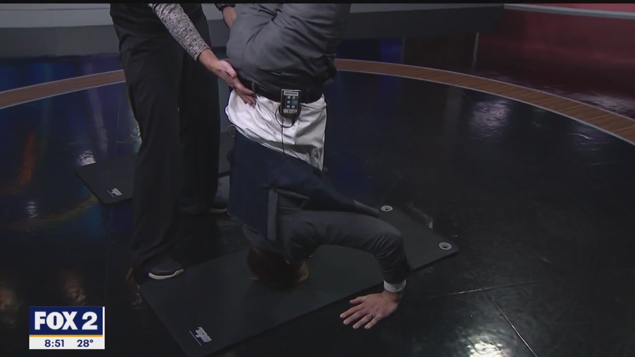 Teri Keller from the YMCA Birmingham is teaching Alan how to do a headstand