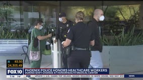 Phoenix police honors healthcare workers with carnations, drive-by parade