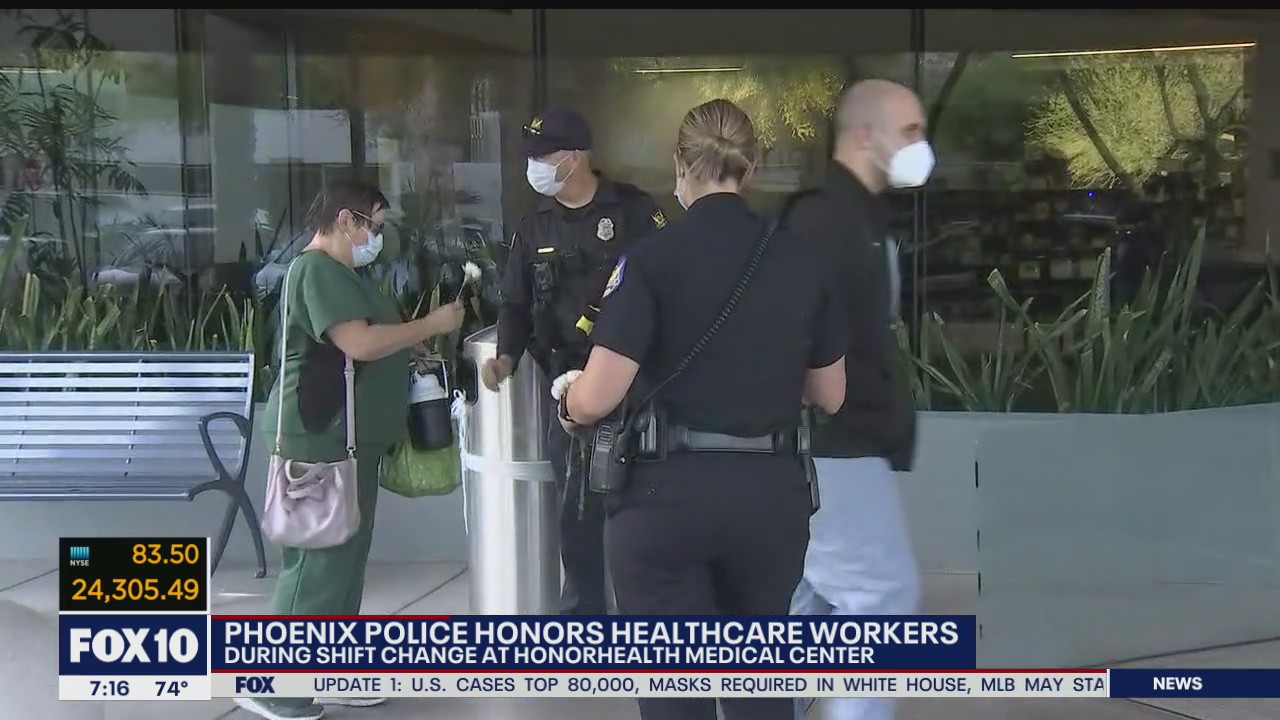 Phoenix police honors healthcare workers with carnations, drive-by parade