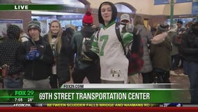 Commuters ride crowded public transit to parade