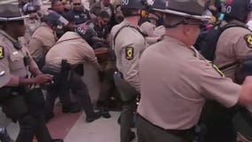 Chicago-area anti-ICE protestors clash with police at facility