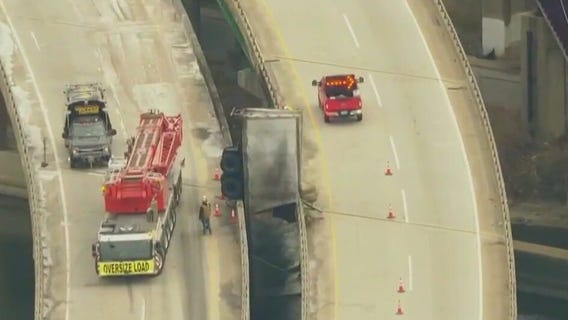 UPS driver found hanging onto bridge pillar after insane crash, Indiana State Police say