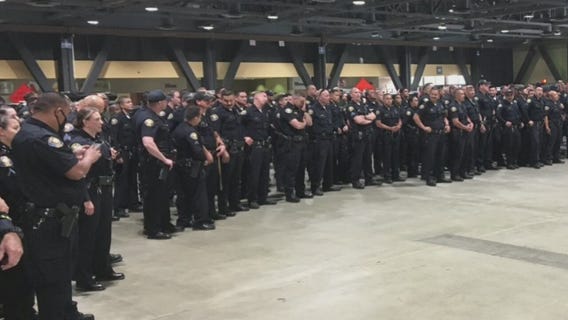 Photo shows dozens of Long Beach police officers standing shoulder-to-shoulder without masks