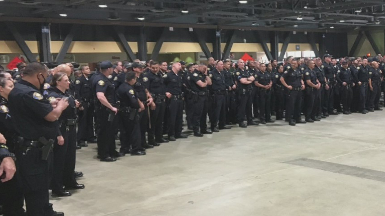 Photo shows dozens of Long Beach police officers standing shoulder-to-shoulder without masks