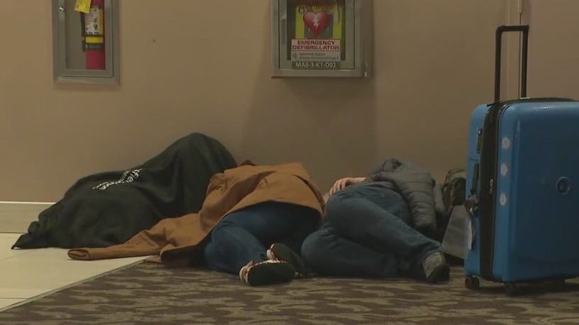 Stranded travelers sleep on Atlanta airport floor after winter storm cancels flights