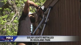 Volunteers install solar-powered streetlights in Highland Park