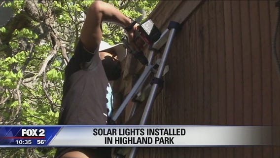 Volunteers install solar-powered streetlights in Highland Park
