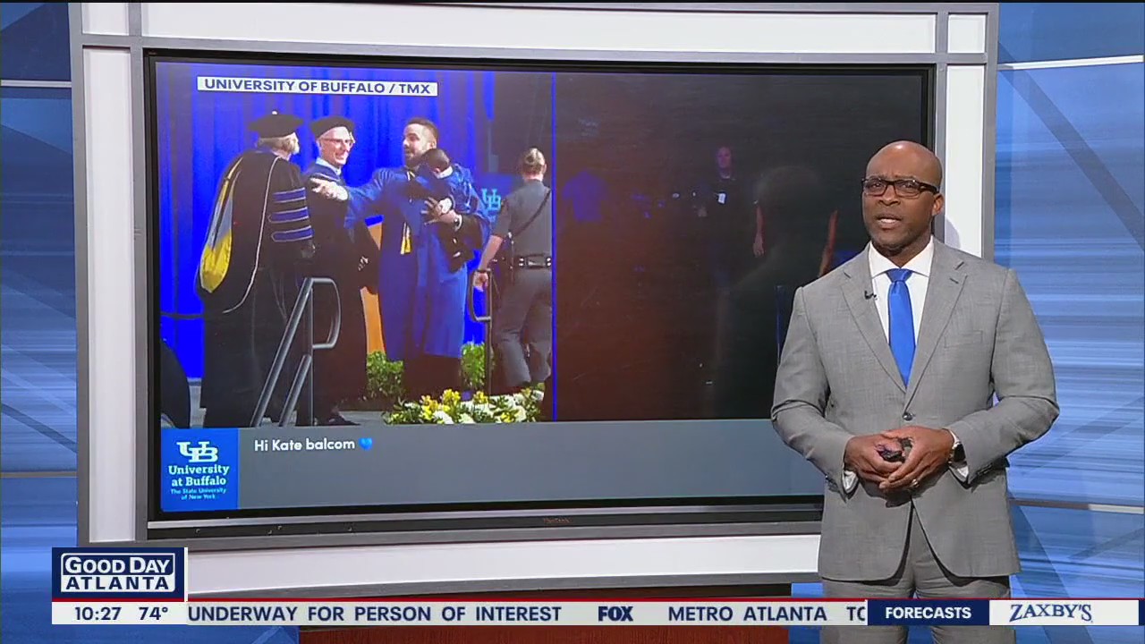 Dad runs on stage with baby during graduation