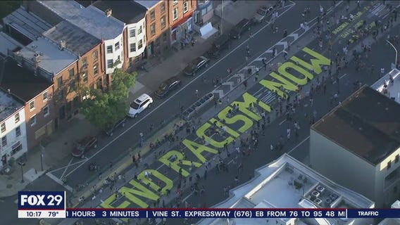 Hundreds paint 'End Racism Now' on Fishtown street
