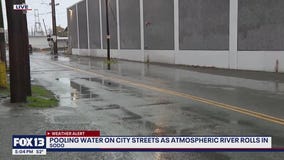 Pooling water on Seattle streets as atmospheric river rolls in