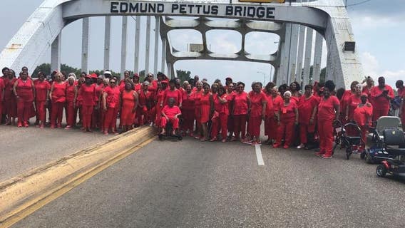 100 Bay Area 'Ladies in Red' cross historic bridge in Selma, Alabama on civil rights tour