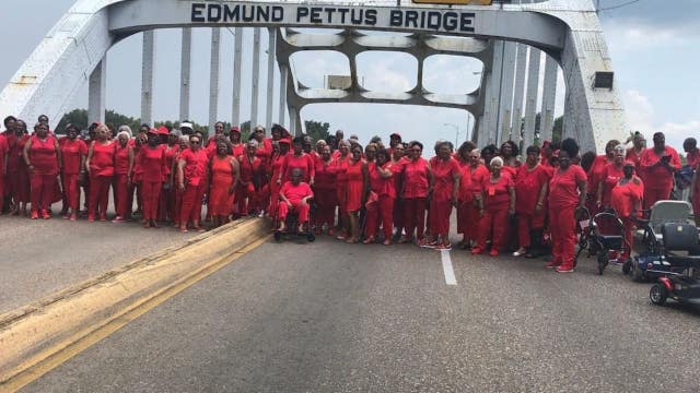 100 Bay Area 'Ladies in Red' cross historic bridge in Selma, Alabama on civil rights tour