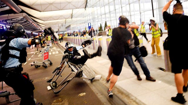 Riot police clash with protesters at Hong Kong airport