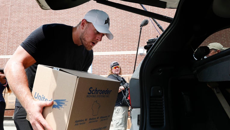 Houston Texans defensive end J.J. Watt places a box of relief supplies in the back of a vehicle for people impacted by Hurricane Harvey on September 3, 2017, in Houston, Texas. Watt's Hurricane Harvey Relief Fund has raised more than $18 million to date to help those affected by the storm. (Photo by Brett Coomer - Pool/Getty Images)