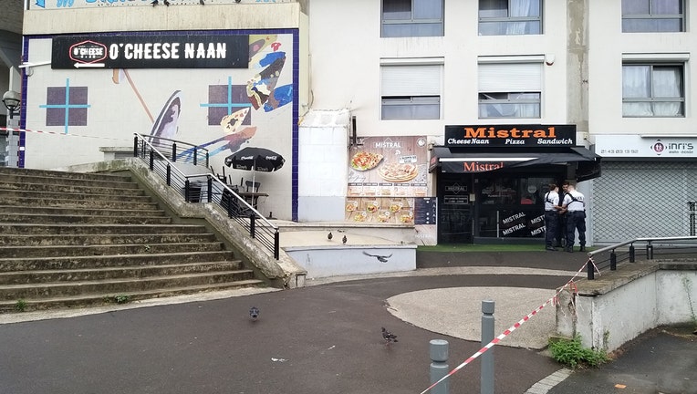 Policemen stand in front of the eatery where a waiter was shot dead by a customer allegedly angry at having to wait for a sandwich, in the eastern Paris suburb of Noisy-le-Grand on August 17, 2019. - The gunman, who witnesses said lost his temper 