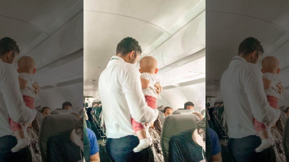 Frontier flight attendant helps calm crying baby