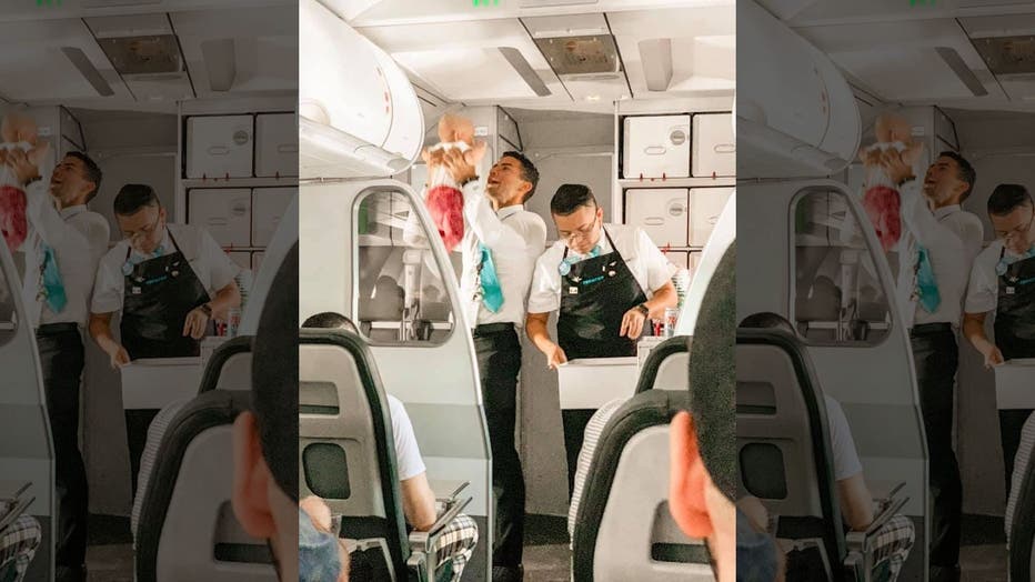 Frontier flight attendant helps calm crying baby