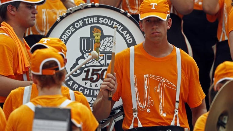 3d00c514-Members of the Pride of the Southland band perform as they wear the University of Tennessee superfan shirt.