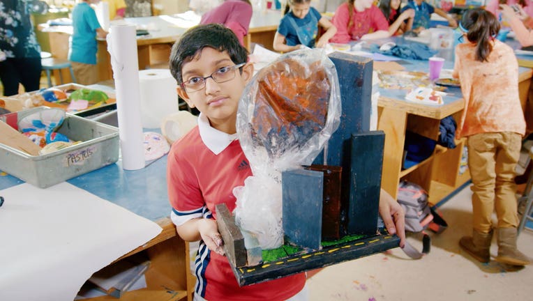 Edward, from Secaucus Middle School, holds up a model of the Sept. 11 attacks on the Twin Towers in the HBO documentary 