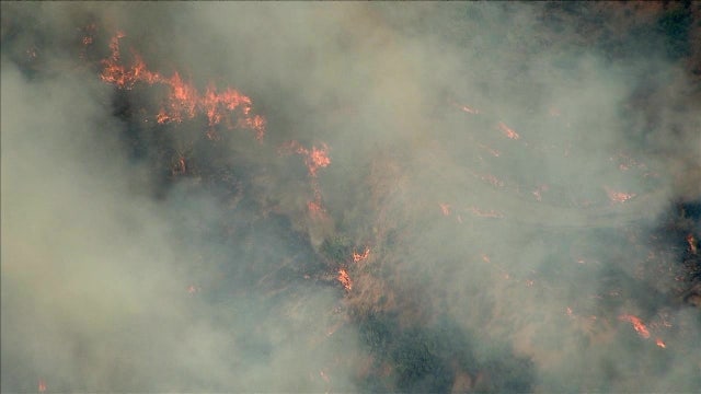 Why are brush fires burning so close to homes and businesses this year?