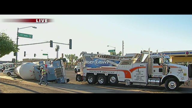 Crews clean up rolled cement truck in Phoenix