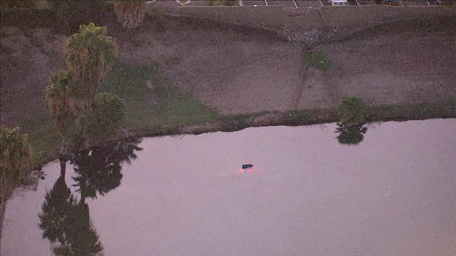 Elderly man killed after car crashes through wall, plunges into Sun City West Pond