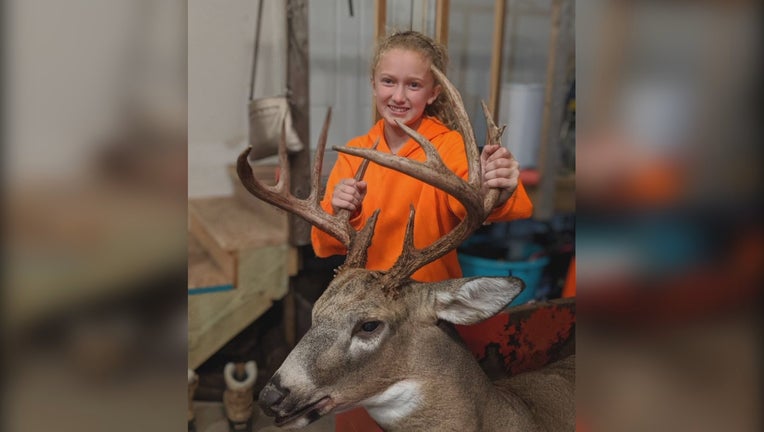 Lilly Mickelson, 11, poses with her trophy buck.