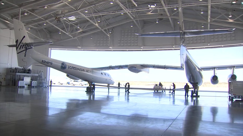 A photo showing a Virgin Galactic spacecraft inside a hanger.