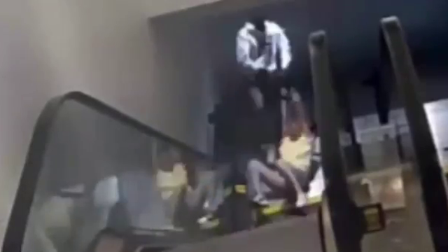 Robbery suspect seen dragging victim down the stairs by purse strap