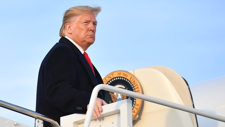 US President Donald Trump makes his way to board Air Force One before departing from Andrews Air Force Base in Maryland on November 4, 2019. - Trump is heading to Lexington, Kentucky for a rally.