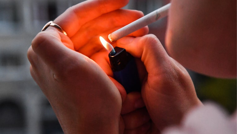 NOVOSIBIRSK, RUSSIA SEPTEMBER 29, 2019: Pictured in this photo illustration is a girl lighting a cigarette on a balcony. Kirill Kukhmar/TASS (Photo by Kirill KukhmarTASS via Getty Images)
