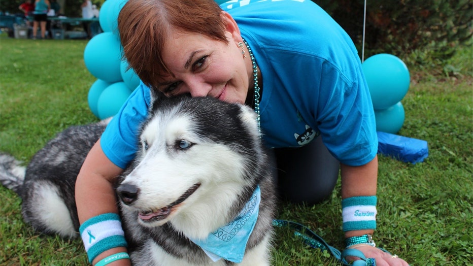 Stephanie Herfel with her husky, Sierra, who discovers Herfel's ovarian cancer re-occurrences before doctors can.