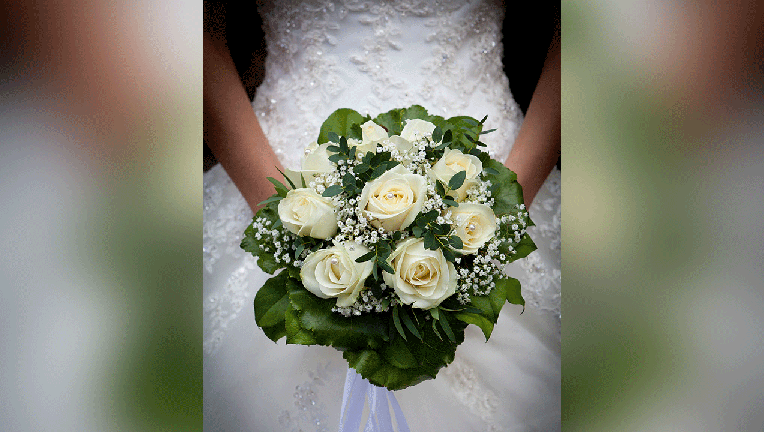 A bride is shown holding a wedding bouquet in a file photo. (Photo by Dünzlullstein bild via Getty Images)