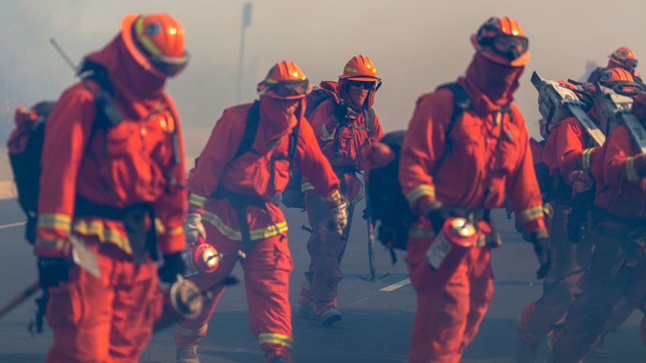 SIMI VALLEY, CA - OCTOBER 30: Inmate firefighters from Oak Glen Conservation Camp near Yucaipa, California fight the Easy Fire on October 30, 2019 near Simi Valley, California. The National Weather Service issued a rare extreme red flag warning for Southern California for gusts that could be the strongest in more than a decade, exceeding 80 mph, as the fast-moving brush fire threatens the Ronald Reagan Presidential Library and nearby residential neighborhoods. (Photo by David McNew/Getty Images)