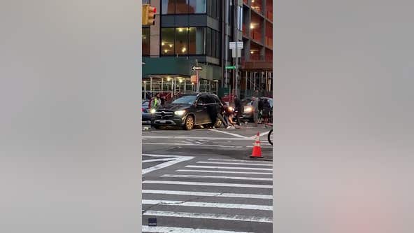 Crowd lifts vehicle to free trapped woman