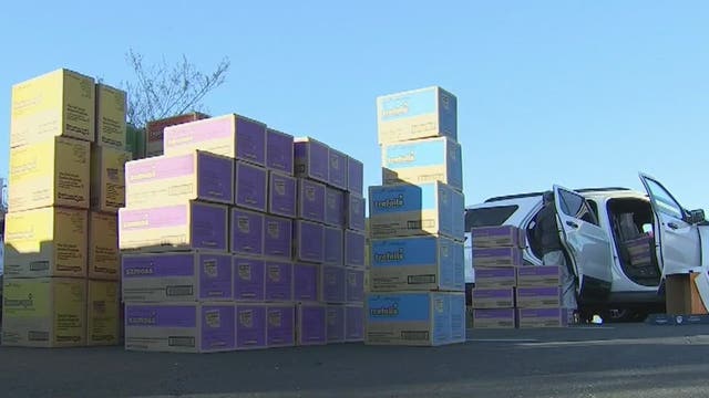 Valley Girl Scouts pick up cookies for delivery
