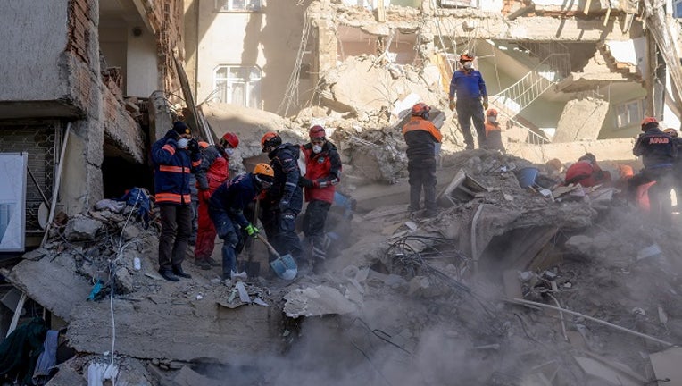 Rescue workers work amid the rubble of a building after an earthquake in Elazig, eastern Turkey, on January 25, 2020. The magnitude 6.8 quake struck in the evening of January 24.