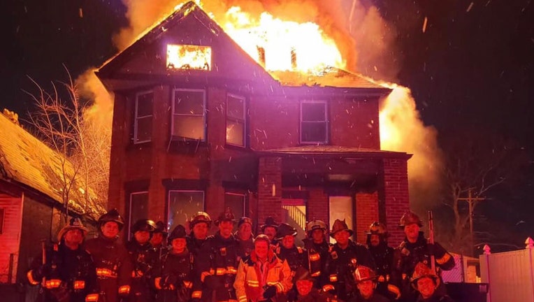 Firefighters in Michigan are in hot water after taking this photo outside a burning house.