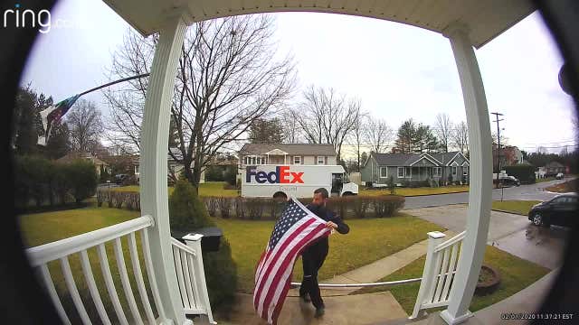 FedEx driver stops to pick up, fold fallen American flag