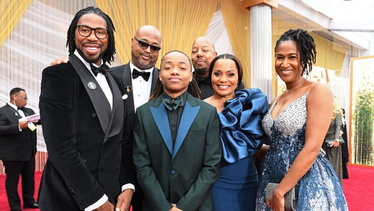 Texas teen Deandre Arnold (C) poses with Karen Rupert (R) and filmmakers of 