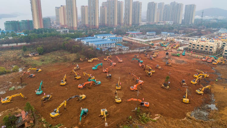 TOPSHOT - This aerial photo on January 24, 2020 shows excavators at the construction site of a new hospital being built to treat patients from a deadly virus outbreak in Wuhan in China's central Hubei province. - China is rushing to build a new hospital in a staggering 10 days to treat patients at the epicentre of a deadly virus outbreak that has stricken hundreds of people, state media reported on January 24. (Photo by STR / AFP) / China OUT (Photo by STR/AFP via Getty Images)