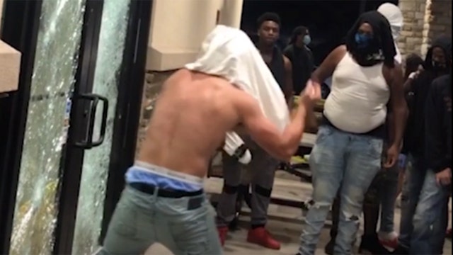 New video shows Tampa looters shattering gas station's doors as smoke pours from Champs Sports