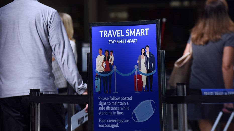 A sign reminding passengers to stay 6 feet apart is seen at