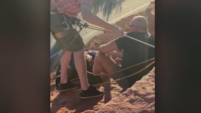 Woman hanging off 70 foot cliff rescued by Chandler PD lieutenant, Dixie State University football players