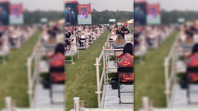 Attendees sit on own platforms at socially distanced outdoor concert held in UK amid pandemic